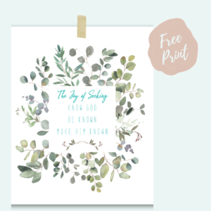 an art print taped to a blue background. the art print says: the joy of seeking. know God, be known, make Him known.
