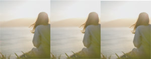 woman looking out over ocean at sunset