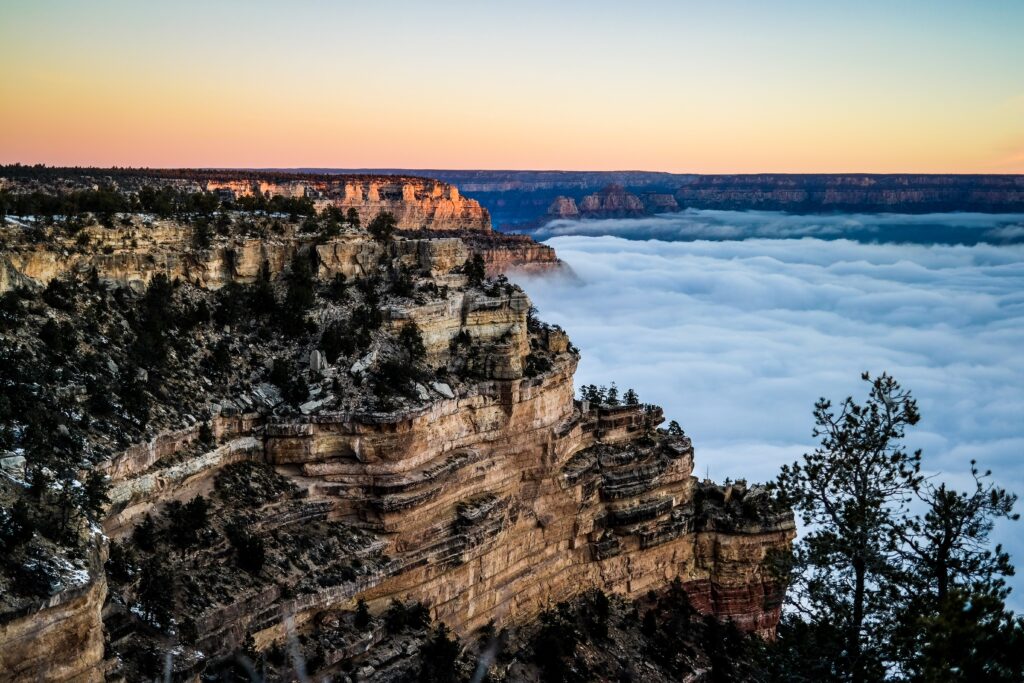 the grand canyon at twilight with low fog