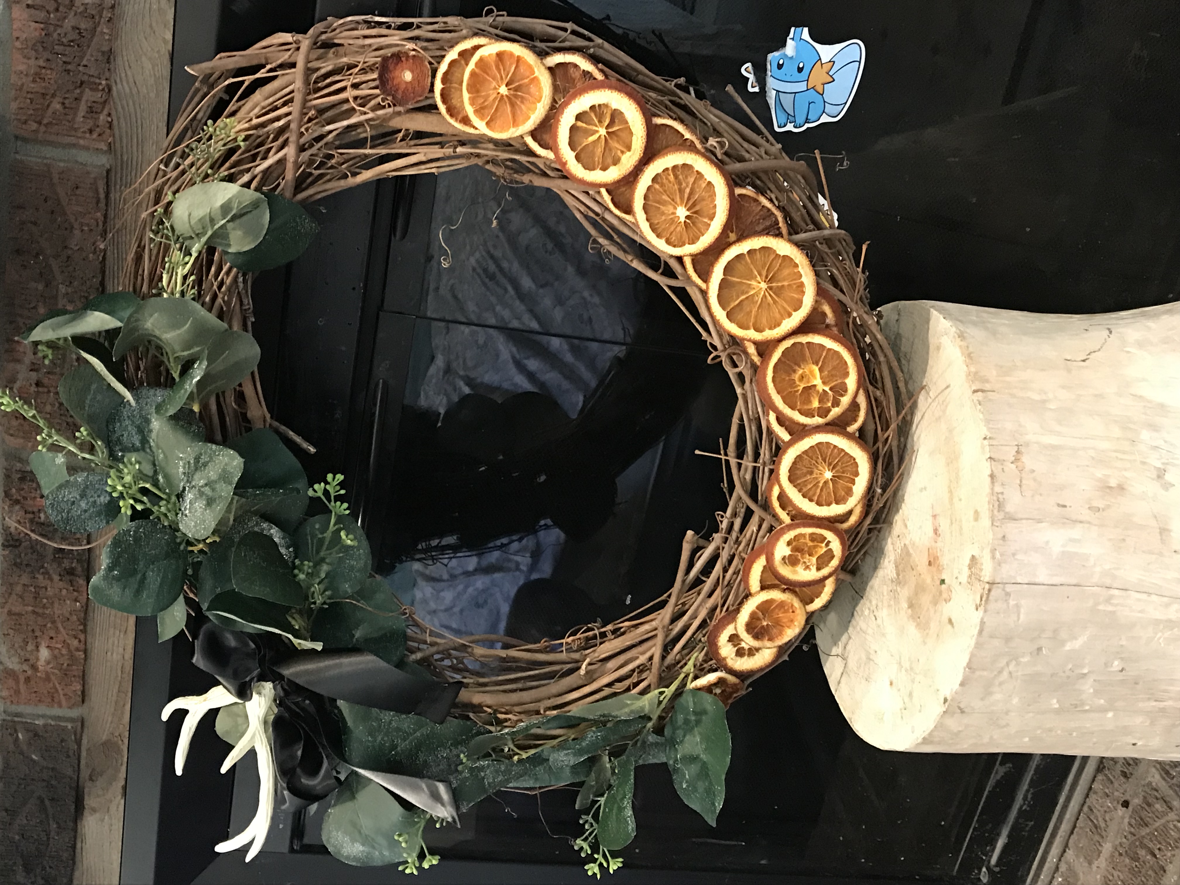 a Christmas wreath made with dried oranges and greenery