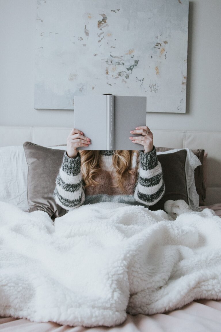 woman reading a book in bed